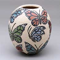 A polychrome jar decorated with a sgraffito and painted butterfly design
 by Leticia Ledezma of Mata Ortiz and Casas Grandes