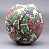 A polychrome jar decorated with a sgraffito-and-painted bird, branch, leaf and berry design, click or tap to see a larger version