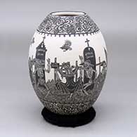 A black and white jar decorated with a sgraffito Day of the Dead at the Cemetery design
 by Hector Javier Martinez of Mata Ortiz and Casas Grandes