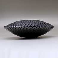 A large flying-saucer decorated with different tooled geometric designs above and below the shoulder, click or tap to see a larger version