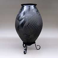A matte and polished black jar with a flared rim and decorated with a sgraffito and painted two-panel serpent and geometric design, click or tap to see a larger version