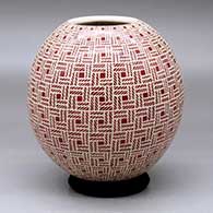 A red on white decorated with a sgraffito basket-weave geometric design
 by Leonel Lopez Sr of Mata Ortiz and Casas Grandes