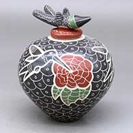 A polychrome jar decorated with a lightly-carved, sgraffito and painted hummingbird, flower, and mesh geometric design, plus a matching hummingbird lid
 by Vidal Corona of Mata Ortiz and Casas Grandes