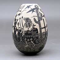 A black on white jar decorated with a sgraffito Day of the Dead design, click or tap to see a larger version
