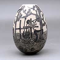 A black on white jar decorated with a sgraffito Day of the Dead design, click or tap to see a larger version