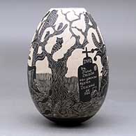 A black on white jar decorated with a sgraffito Day of the Dead design, click or tap to see a larger version