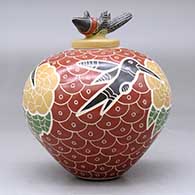 A polychrome jar decorated with a lightly-carved, sgraffito and painted hummingbird, flower, and mesh geometric design, plus a matching hummingbird lid, click or tap to see a larger version