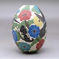 A polychrome jar decorated with a sgraffito and painted bird, butterfly, branch, leaf and flower design, click or tap to see a larger version