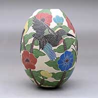 A polychrome jar decorated with a sgraffito and painted bird, butterfly, branch, leaf and flower design, click or tap to see a larger version
