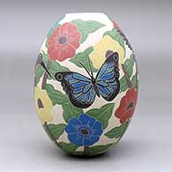 A polychrome jar decorated with a sgraffito and painted bird, butterfly, branch, leaf and flower design, click or tap to see a larger version