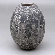 A black on white jar decorated with a sgraffito Night of the Dead at the Cemetery with Native Americans and geometric design
 by Hector Javier Martinez of Mata Ortiz and Casas Grandes