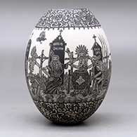 A black on white jar decorated with a sgraffito Day of the Dead at the cemetery with Native Americans design, click or tap to see a larger version