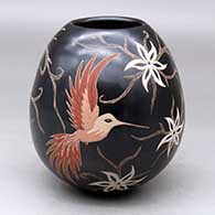 A polychrome jar with a sgraffito and painted hummingbird, vine, flower and geometric design
 by Elicena Cota of Mata Ortiz and Casas Grandes