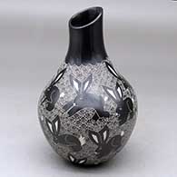 A black on white jar with an organic opening and decorated with a sgraffito wildlife and geometric design
 by Alex Ortega of Mata Ortiz and Casas Grandes