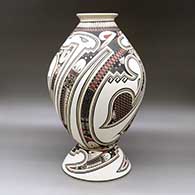 A polychrome jar decorated with a lightly carved and painted Paquime serpent, sickle and geometric design, with a custom matching stand, click or tap to see a larger version