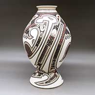 A polychrome jar decorated with a lightly carved and painted Paquime serpent, sickle and geometric design, with a custom matching stand, click or tap to see a larger version