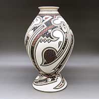 A polychrome jar decorated with a lightly carved and painted Paquime serpent, sickle and geometric design, with a custom matching stand, click or tap to see a larger version