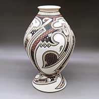 A polychrome jar decorated with a lightly carved and painted Paquime serpent, sickle and geometric design, with a custom matching stand
 by Lazaro Ozuna of Mata Ortiz and Casas Grandes