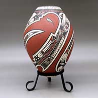 A polychrome jar lightly carved and painted with a three-panel serpent, sickle and geometric design, click or tap to see a larger version