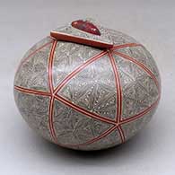 A polychrome jar with a triangular lid with an inlaid stone and decorated with a spiral fineline and geometric design
 by Oralia Lopez of Mata Ortiz and Casas Grandes