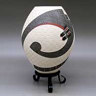 A polychrome jar decorated with a two-panel carved, sgraffito and painted stylized serpent, checkerboard and geometric design, click or tap to see a larger version