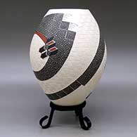 A polychrome jar decorated with a two-panel carved, sgraffito and painted stylized serpent, checkerboard and geometric design, click or tap to see a larger version