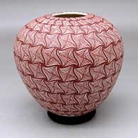 A red on white jar decorated with a geometric design from top to bottom
 by Aide Gonzales of Mata Ortiz and Casas Grandes
