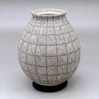 A black on white jar with a flared rim and a geometric design all over
 by Aide Gonzales of Mata Ortiz and Casas Grandes