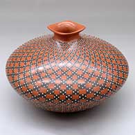 A polychrome jar with a square rolled lip and decorated with a checkerboard and geometric design
 by Yoly Ledezma of Mata Ortiz and Casas Grandes