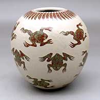 A polychrome jar decorated with a sgraffito and slipped frog and ring-of-feathers geometric design
 by Leonel Lopez Sr of Mata Ortiz and Casas Grandes