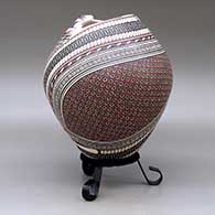 A polychrome jar with a geometric cut opening and decorated with a two-panel tiny square and geometric design, click or tap to see a larger version