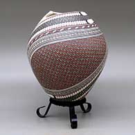 A polychrome jar with a geometric cut opening and decorated with a two-panel tiny square and geometric design, click or tap to see a larger version