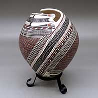 A polychrome jar with a geometric cut opening and decorated with a two-panel tiny square and geometric design
 by Mirna Hernandez of Mata Ortiz and Casas Grandes