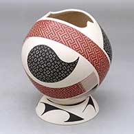 A polychrome jar with a geometric cut opening and decorated with a geometric design, plus a matching custom stand
 by Elias Pena of Mata Ortiz and Casas Grandes