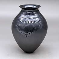 A black on black jar with a rolled lip and decorated with a knife-edge, tiny square and geometric design
 by Susy Martinez of Mata Ortiz and Casas Grandes