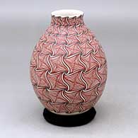 A polychrome vase decorated with a geometric design
 by Aide Gonzalez of Mata Ortiz and Casas Grandes
