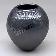 A black on black jar decorated with a painted and sgraffito geometric design
 by Susy Martinez of Mata Ortiz and Casas Grandes