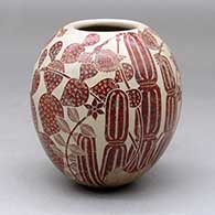A polychrome jar decorated with a sgraffito bird, flower, leaf and vine design
 by Abel Lopez of Mata Ortiz and Casas Grandes