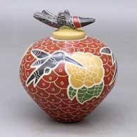 A polychrome jar decorated with a lightly carved, sgraffito and painted hummingbird, flower and geometric design, with a matching hummingbird lid
 by Vidal Corona of Mata Ortiz and Casas Grandes