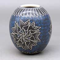 A polychrome jar decorated with a sgraffito and painted bird medallion and geometric design surrounded by a multi-color slipped surface
 by Leonel Lopez Sr of Mata Ortiz and Casas Grandes