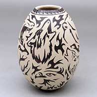 A polychrome jar decorated with a sgraffito wildlife, optical illusion and geometric design
 by David Bejarano of Mata Ortiz and Casas Grandes