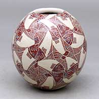 A polychrome jar decorated with a sgraffito fish and geometric design
 by Leonel Lopez Sr of Mata Ortiz and Casas Grandes