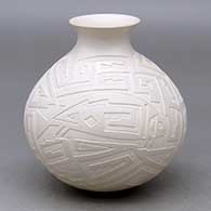 A white jar with a rolled lip and decorated with a lightly carved and sgraffito Mimbres fish and geometric design
 by Claudia Ledezma of Mata Ortiz and Casas Grandes