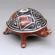A polychrome turtle figure decorated with a geometric design on its shell
 by Jorge Corona of Mata Ortiz and Casas Grandes