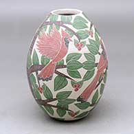 A polychrome jar decorated with a sgraffito and painted bird, branch, leaf and berry design
 by Karla Flores of Mata Ortiz and Casas Grandes