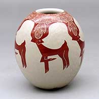 A red on white jar decorated with a sgraffito deer and geometric design
 by Leonel Lopez Sr of Mata Ortiz and Casas Grandes