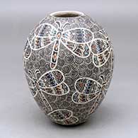 A polychrome jar decorated with a lightly carved, sgraffito and painted dragonfly and geometric design
 by Ailadi Mijarez of Mata Ortiz and Casas Grandes