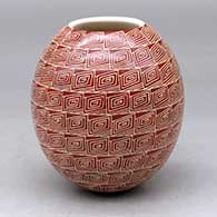 A red on white jar decorated with a sgraffito square spiral geometric design from top to bottom
 by Leonel Lopez Jr of Mata Ortiz and Casas Grandes