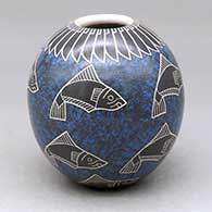 A polychrome jar decorated with a sgraffito and painted fish and geometric design
 by Leonel Lopez Sr of Mata Ortiz and Casas Grandes