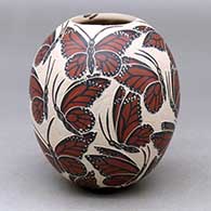 A polychrome jar decorated with a butterfly design
 by Leticia Ledezma of Mata Ortiz and Casas Grandes